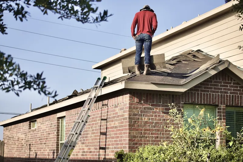 Professional roofer working on a residential roof in Shumaker Crossing